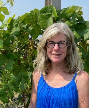 wife of eye tissue donor at organic farm with vineyard grapes